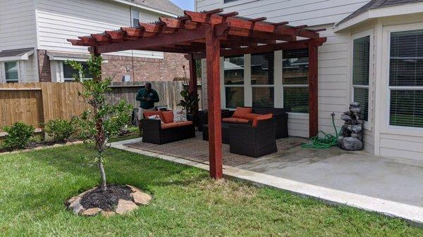 Stained pergola with smoke covered panels