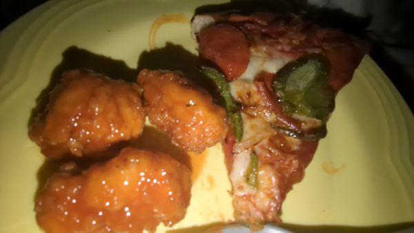 Delicious hot boneless wings and pizza with pepperon i, onions and peppers