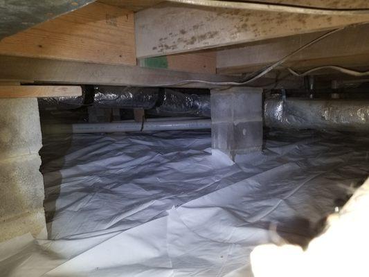 Clean crawl space with new vapor barrier