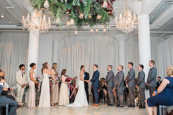 Say 'I do' beneath a floral canopy. Photo by Moonhouse Productions.