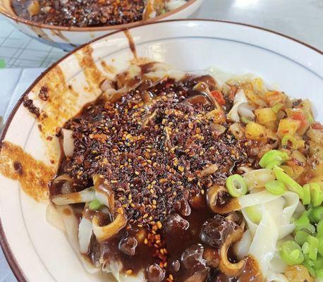 **Zha Jiang Noodles**  
   *Hand-pulled noodles with onions, mushrooms, and minced pork, seasoned with house-made Zha Jiang sauce.*