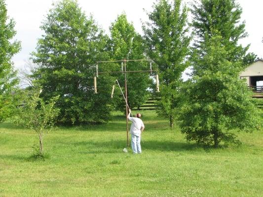 Filling the bird feeders with seed from Feeders Supply