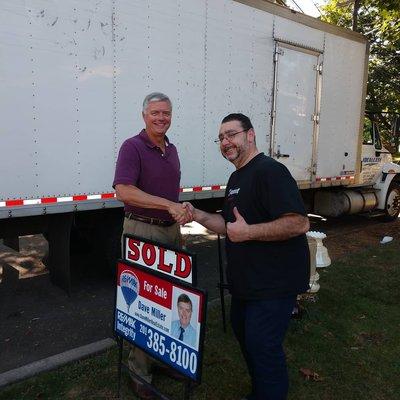 Dave Miller puts up the "Sold" sign on my property in Bergenfield!