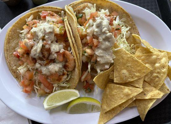 One grilled shrimp and the other grilled fish tacos