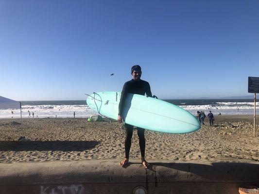 Surfboard and beach next to surf shop