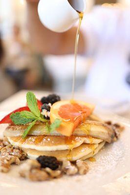 Pancakes with fried bananas and candied walnuts.