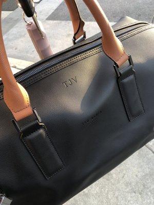 Embossed monogram on leather duffle