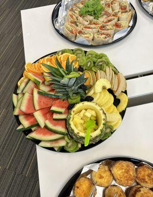 Brunch event-fruit plate, mini quiches, and wraps