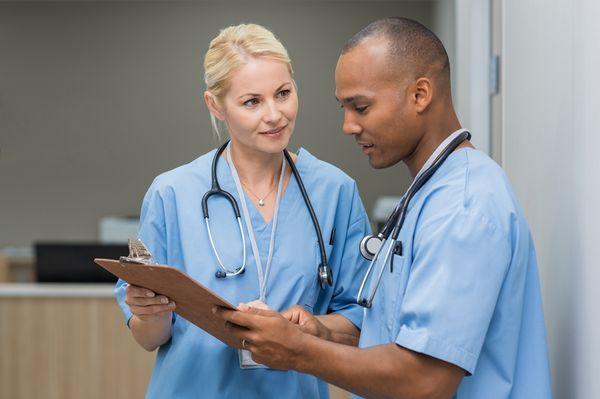 Pair of doctors discussing a patient.