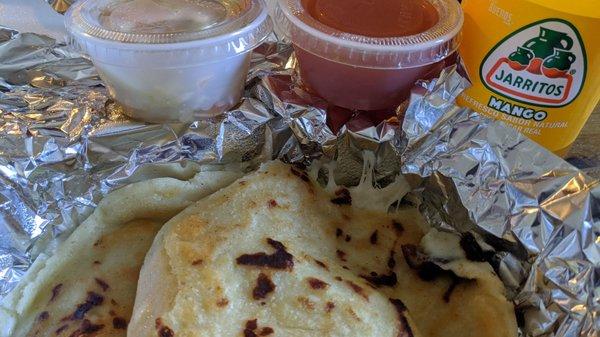 Cheese pupusas, hot sauce, and curtido.