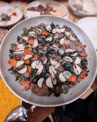 Southeast dish kebab. Lamb and beef, pearl onions, tomato, beet greens, ginger, Serrano, yogurt, and served with turmeric rice.