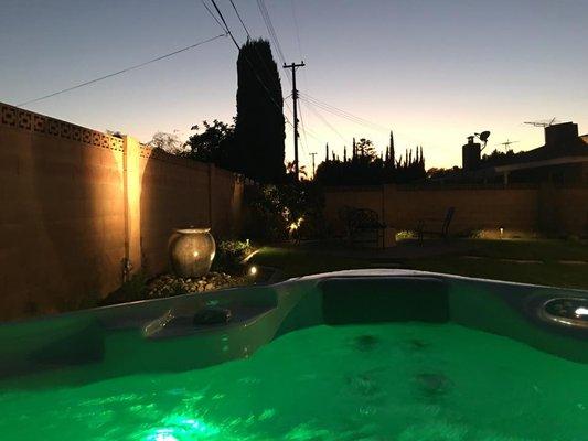 spotlights on the trees and fountain. downlights scattered throughout.