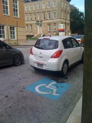 PARKatlanta illegally parked in handicap by Grady, so they can walk around the Georgia State University area to issue tickets.