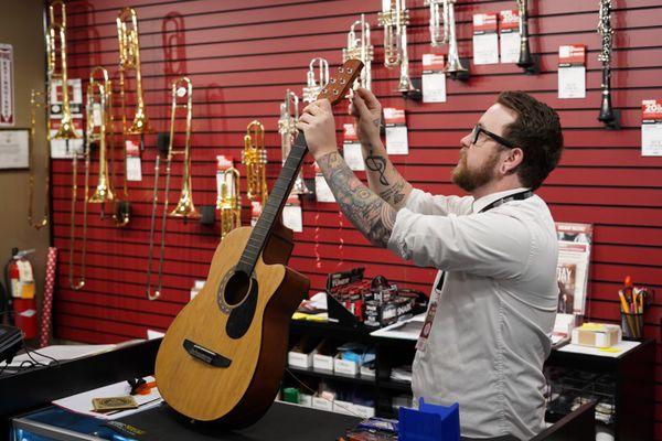 Chris stringing a guitar