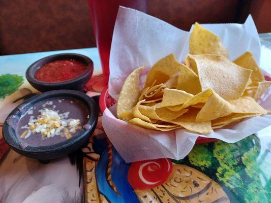 Chips with salsa and black refried beans.