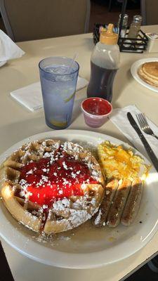 belgian waffles w. strawberries & powdered sugar, scrambled eggs w. cheese, turkey sausage, and water w. 3 lemons