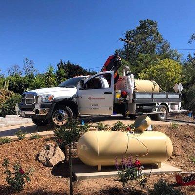 Placing a new tank for a residential customer with our boom truck.