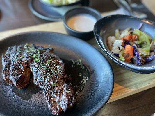 14 oz. Ribeye Steak with creamy horseradish and steamed vegetables.