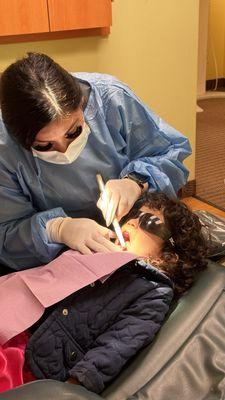 The dental hygienist, Claudia, brushing my three year old's teeth.