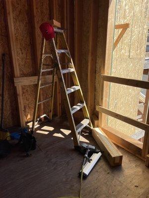 Adding the bracing to the sheer wall with a nail gun.