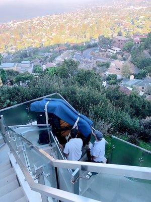 Moving a Baby Grand Piano up a cliffside stairway with three tight turns in Laguna Beach.