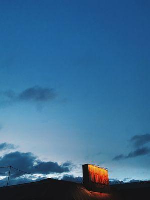 Tim's tavern sign with big blue sky