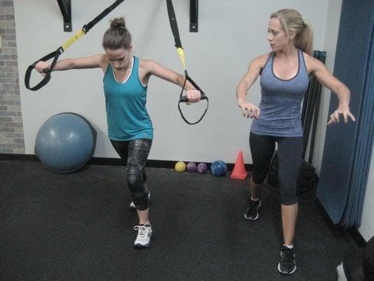 Melissa takes Katie through the TRX chest press.