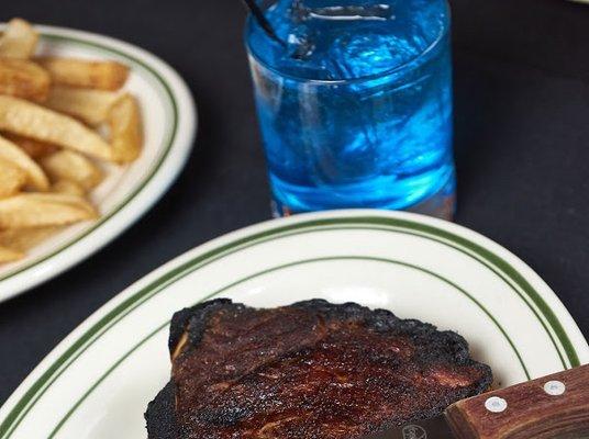 Dry aged, Ribeye Steak, Truffle Fries & Deep Blue Sky cocktail.