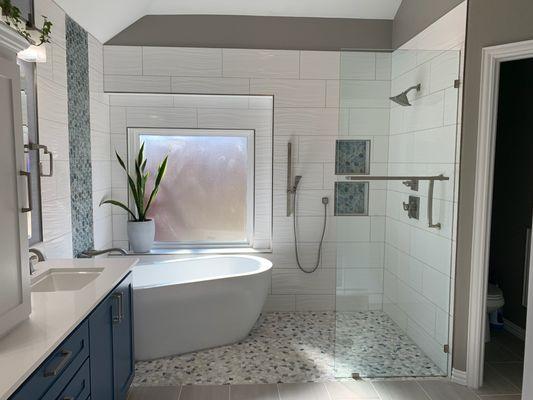 Custom built Wet Room with a giant bathtub and custom built and painted cabinets.