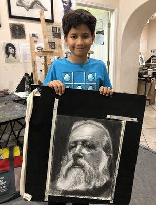 10-year old Akshay with his latest charcoal portrait, having studied at Ichen Art Academy for a few years.