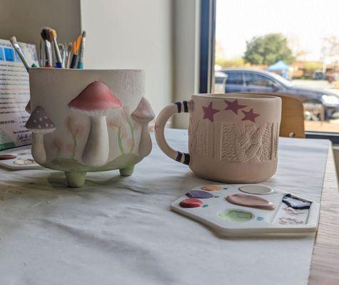 A mushroom pot I painted and a Taylor Swift inspired sweater mug my bff painted :)