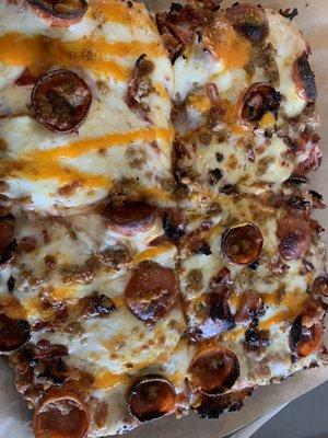 Cup and char with sausage pan pizza with buffalo drizzle