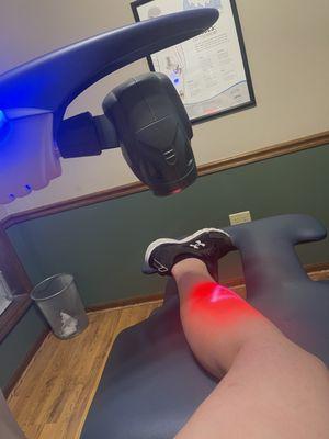 Helping heal my torn calf with red light therapy.