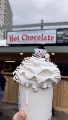 The famous snowman hot chocolate, hot chocolate, whipped cream, sprinkles, chocolate drizzle, cherry and snowman on top!