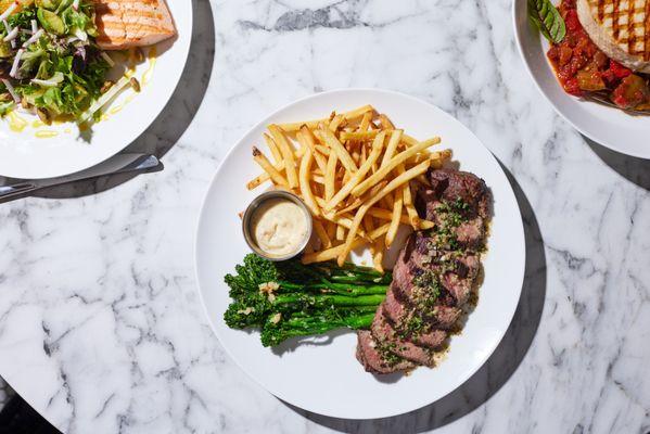 Steak Frites: Includes grilled broccolini, roasted garlic aioli, and French fries.