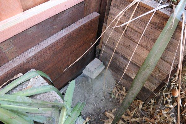 Cement powder and garbage in between pots.