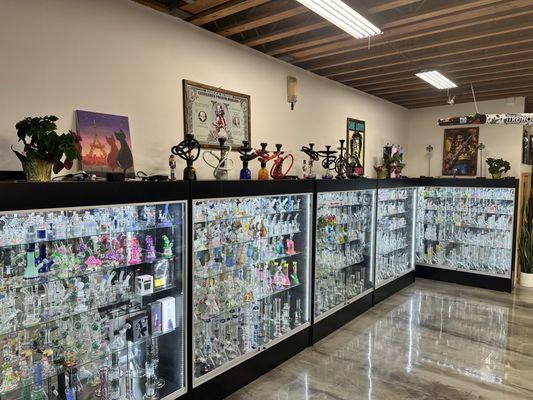 More expensive glass pieces along the wall to the left. Those cases are over 6' tall