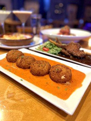 Arancini Di Aragosta Lobster, saffron, mozzarella riceballs, Vodka tomato cream sauce.