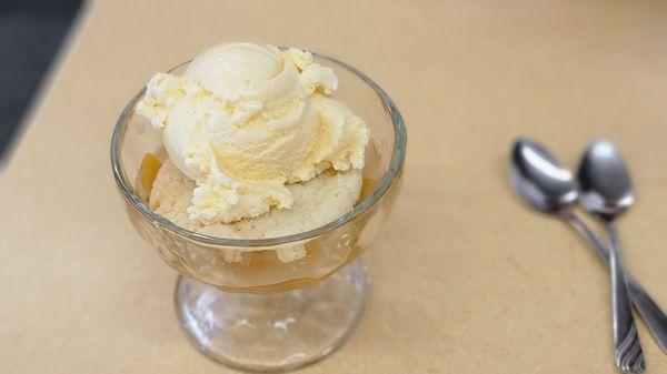 Warm, soft cookie on peach cobbler with ice cream