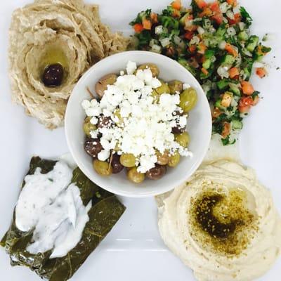 Veggie plate: hummus, baba ghannouj,cucumber salad, dolmas and olives, with naan.