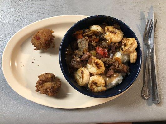 Shrimp, sausage, ham and grits with hush puppies.