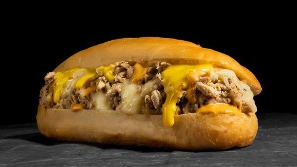 Chicken Chipotle Cheesesteak: Thinly sliced chicken, provolone, cheddar sauce, griddled onions, chipotle sauce on a toasted hoagie roll