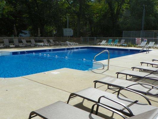 The swimming pool is a central attraction, with lots of lounge chairs to relax in.