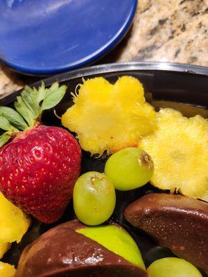 pineapple core flowers, old and browning grapes, bruised strawberries