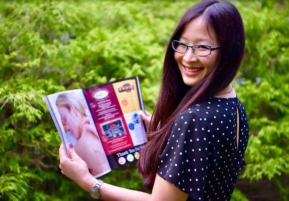 Dr. Pema reading the September 2018 issue of Bergen Magazine featuring her as the best acupuncturist