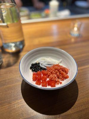 Milk pudding topped with brown sugar boba, young coconut strips, strawberry granita and jicama.