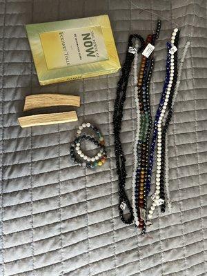 Beads for jewelry making, bracelets, palo santo sticks, and motivational cards.