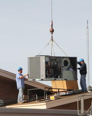 Installing a new gas-elec unit on the roof.