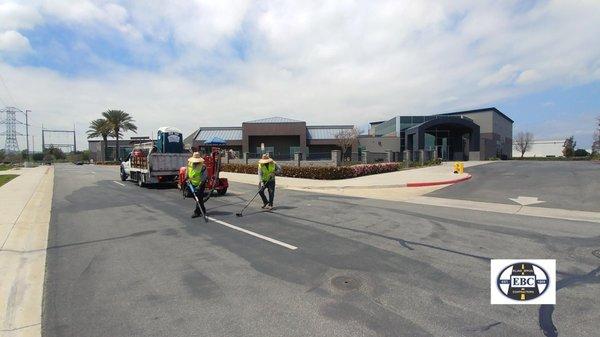 Cracksealing with hot rubber before sealcoating.