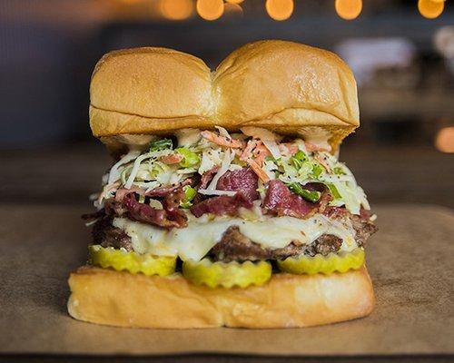 THE MENSCH – white american cheese, pickles, pastrami, haus slaw, secret sauce